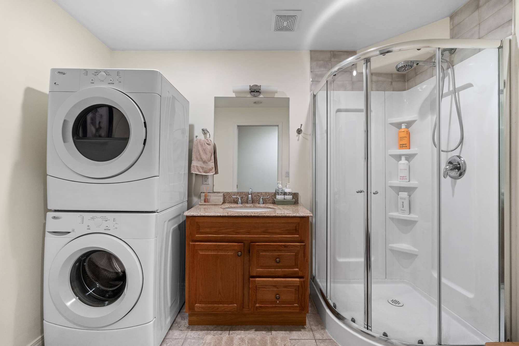 Bathroom with glass shower and in-suite laundry
