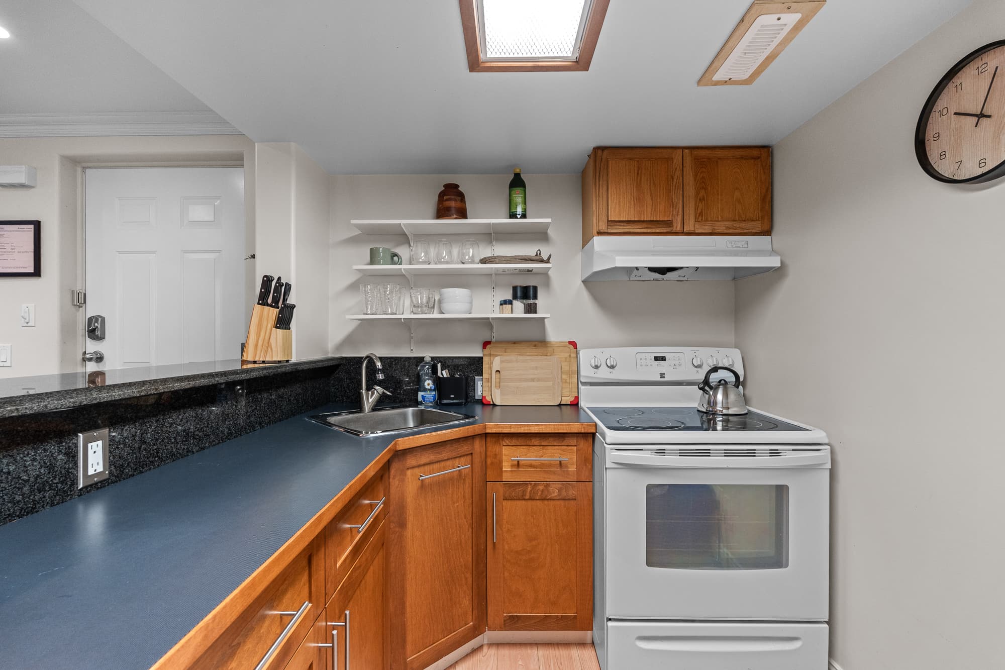 Fully equipped kitchenette with dark quartz countertops
